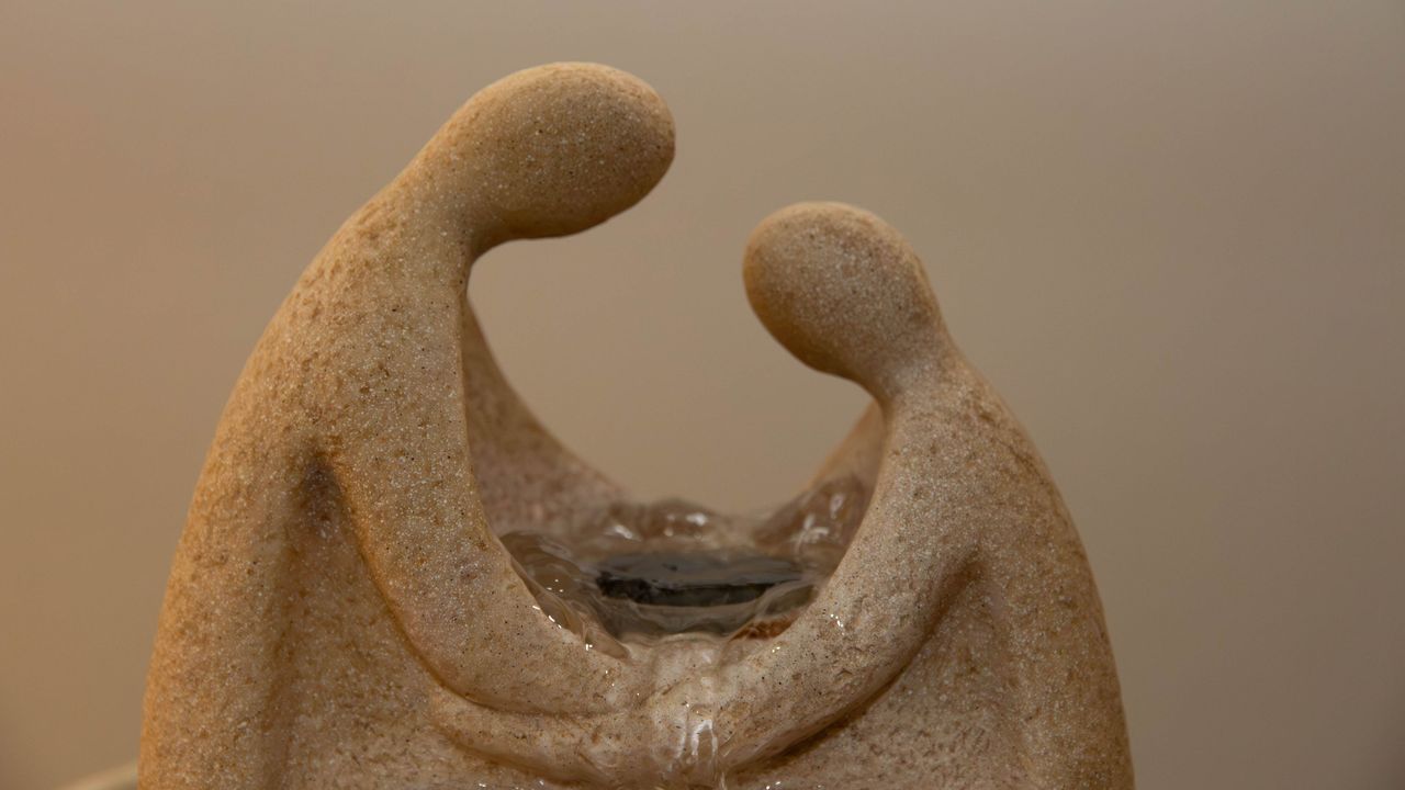 Two carved stone figures facing each other