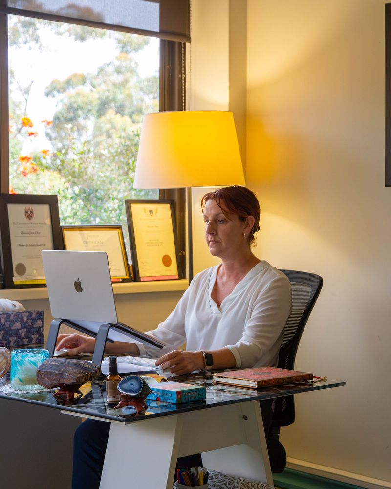 Amanda Oliver working at her desk in the West Perth consulting room
