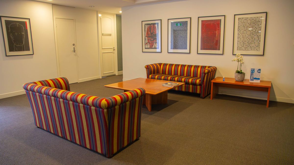 The waiting area, with striped sofas and framed prints